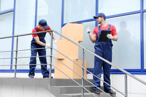 Removal team handling household furniture in Sydenham
