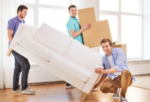 Movers loading household items into a removal van