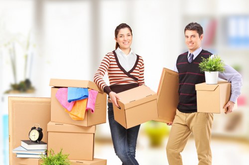 Commercial office relocation team arranging items at a new workspace