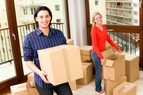 Packed moving boxes and furniture in a Sydenham home removal